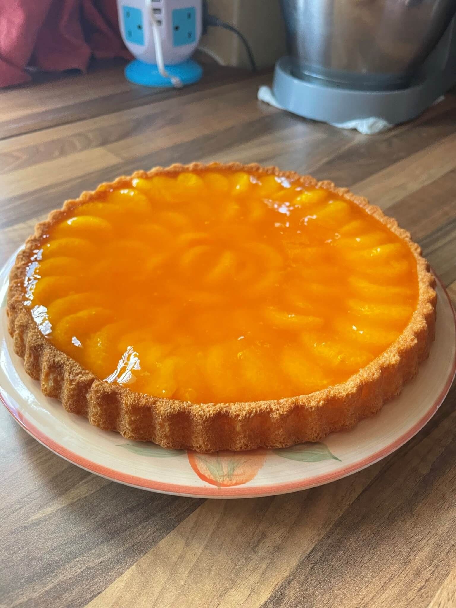A Mandarin tart on a plate.