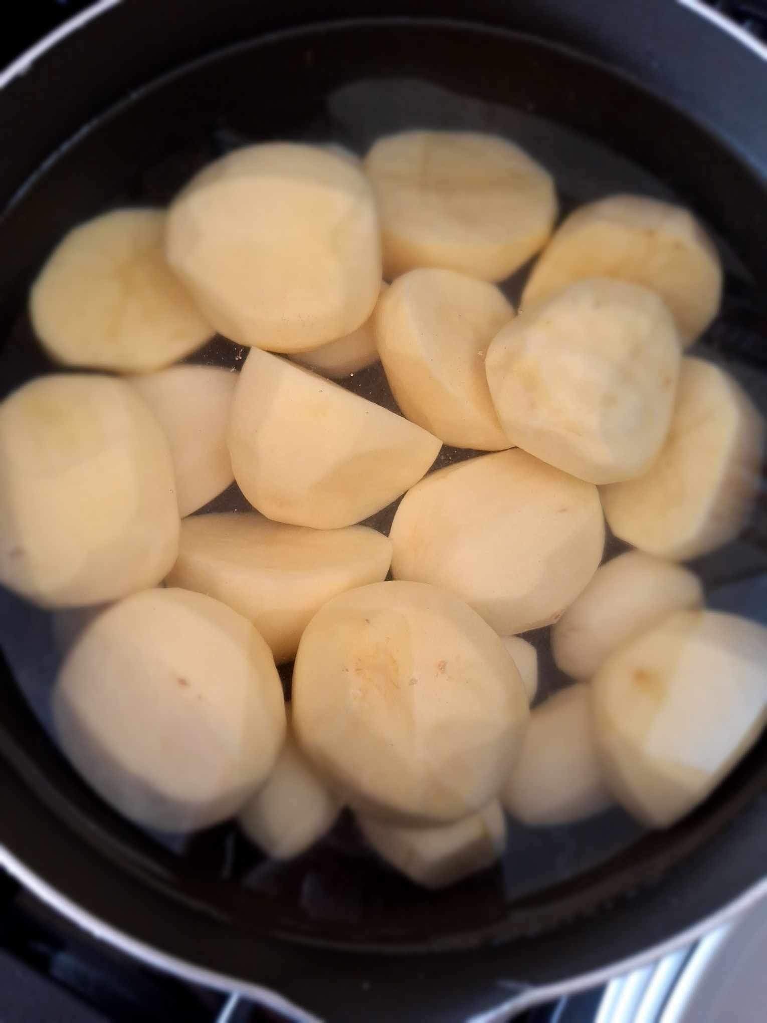 Peeled Maris Piper potatoes ready for parboiling to make perfect crispy roast potatoes