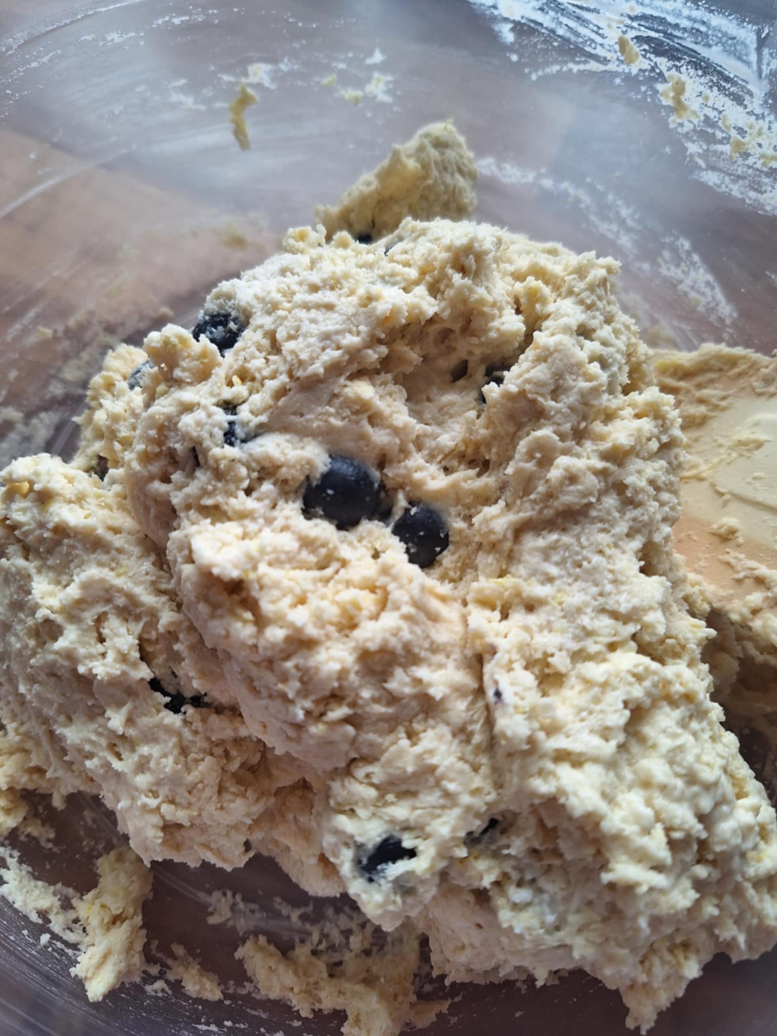 Close-up of scone dough showing blueberries being gently folded into the mixture