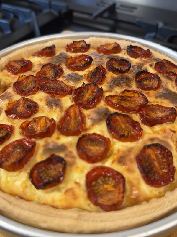 Roasted tomato and cheddar tart recipe with golden melted cheese and caramelised cherry tomatoes