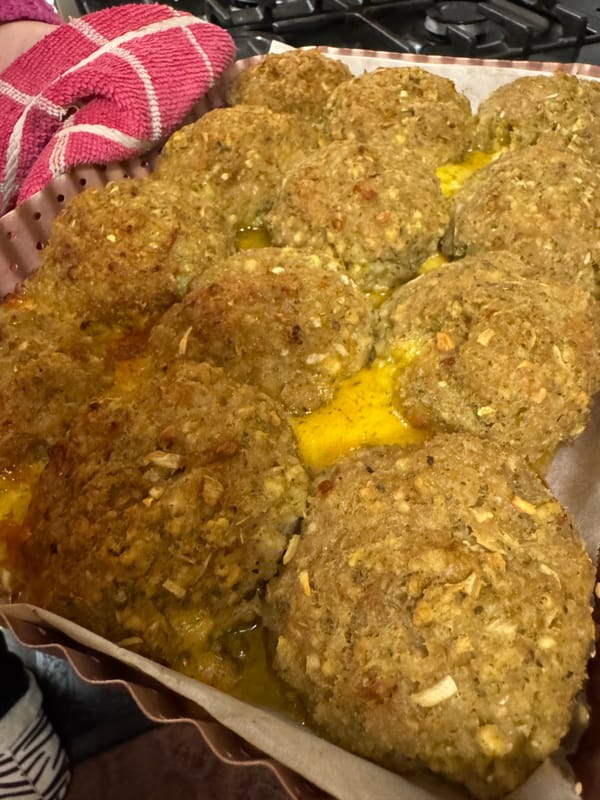 a pan of golden brown cheese stuffing bites. They look delicious and perfect for a holiday meal