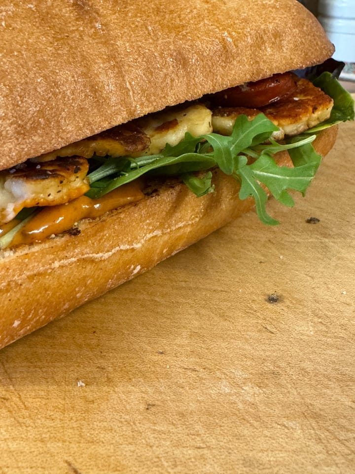 Delicious sandwich with Chipotle Chorizo and Halloumi on a table